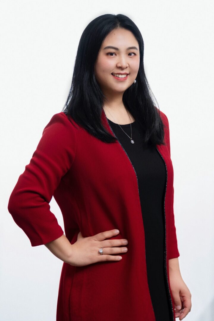 A woman in red jacket posing for the camera.